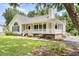 Lovely single-story home featuring a wraparound porch and manicured landscaping at 117 S Woodstone Dr, Archer Lodge, NC 27527