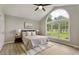 Serene main bedroom with a large window, a ceiling fan, and neutral decor for a calming atmosphere at 117 S Woodstone Dr, Archer Lodge, NC 27527