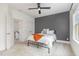 Bedroom featuring a bed with a white comforter, a gray accent wall, and a ceiling fan at 1172 Cottonsprings Dr, Wendell, NC 27591