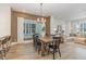 Dining room with modern light fixture and view into the living room and kitchen at 1172 Cottonsprings Dr, Wendell, NC 27591