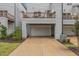 Townhome exterior with a garage, an upper deck, well-maintained landscaping, and a private driveway at 1172 Cottonsprings Dr, Wendell, NC 27591