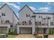 Exterior of a townhome with a garage, a balcony, well-kept lawn, and nice landscaping at 1172 Cottonsprings Dr, Wendell, NC 27591