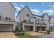 Townhome exterior with a garage, an upper deck, well-maintained landscaping, and private driveway at 1172 Cottonsprings Dr, Wendell, NC 27591