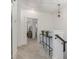 Upstairs hallway with neutral carpet, a decorative light fixture, and access to the rooms at 1172 Cottonsprings Dr, Wendell, NC 27591