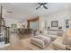 Open-concept living area with hardwood floors, modern furniture, and seamless flow into the kitchen at 1172 Cottonsprings Dr, Wendell, NC 27591