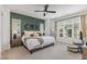 Main bedroom with a large window, green accent wall, and neutral-toned decor at 1172 Cottonsprings Dr, Wendell, NC 27591