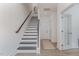 Modern stairway with dark railing and light wood floors leading to the upper level at 1172 Cottonsprings Dr, Wendell, NC 27591