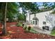 Spacious backyard featuring meticulous landscaping, a patio, and a classic white exterior at 121 Trevor Ridge Dr, Holly Springs, NC 27540