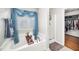 Bright bathroom with a soaker tub and walk-in shower with blue curtains and a walk-in closet at 121 Trevor Ridge Dr, Holly Springs, NC 27540