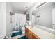 Neutral bathroom with a single sink, large mirror, and shower/tub combo with updated fixtures at 121 Trevor Ridge Dr, Holly Springs, NC 27540