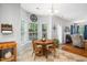 Bright breakfast nook with hardwood and tile, adjacent to a cozy living room with fireplace at 121 Trevor Ridge Dr, Holly Springs, NC 27540
