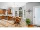 Charming breakfast nook with round wooden table and chairs, surrounded by natural light at 121 Trevor Ridge Dr, Holly Springs, NC 27540