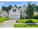 Lovely two-story home with a lush front lawn, green foliage, and a welcoming front entrance at 121 Trevor Ridge Dr, Holly Springs, NC 27540