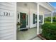 Inviting front porch with decorative wreath, green door, potted plant, and bench seating at 121 Trevor Ridge Dr, Holly Springs, NC 27540