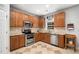 Well-equipped kitchen with stainless steel appliances, oak cabinets, and patterned tile flooring at 121 Trevor Ridge Dr, Holly Springs, NC 27540