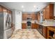 Spacious kitchen with stainless steel appliances, oak cabinets, and patterned tile flooring at 121 Trevor Ridge Dr, Holly Springs, NC 27540