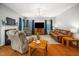 Spacious living room featuring a fireplace, TV, and comfortable seating on hardwood floors at 121 Trevor Ridge Dr, Holly Springs, NC 27540