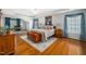 Spacious main bedroom with a hardwood floor, tray ceiling, decor, and lots of natural light at 121 Trevor Ridge Dr, Holly Springs, NC 27540