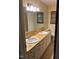 Bathroom featuring double sinks with wood countertop, accompanied by light cabinetry, and ample space at 1225 Fairlane Rd, Cary, NC 27511