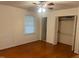 Bedroom with hardwood flooring, window, closet with sliding doors, and ceiling fan at 1225 Fairlane Rd, Cary, NC 27511