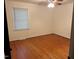 Cozy bedroom with hardwood floors, neutral walls, single window and classic ceiling fan at 1225 Fairlane Rd, Cary, NC 27511