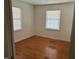 Bright bedroom with hardwood flooring, neutral walls and featuring two windows to allow for plenty of natural light at 1225 Fairlane Rd, Cary, NC 27511