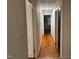 Hallway features hardwood flooring and neutral paint leading to the bedroom at 1225 Fairlane Rd, Cary, NC 27511