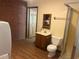 Laundry room with brick wall, toilet and washer/dryer connections at 1225 Fairlane Rd, Cary, NC 27511