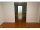 Living room with hardwood floors leading to another room at 1225 Fairlane Rd, Cary, NC 27511
