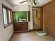 Bright living room features a brick accent wall, windows, built-in storage, and ceiling fan at 1225 Fairlane Rd, Cary, NC 27511