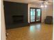 Spacious living room with a dark brick fireplace, ceiling fan, and access to a sunroom at 1225 Fairlane Rd, Cary, NC 27511