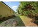 Expansive backyard featuring lush greenery, partial fencing, and a quaint patio area at 1261 Grovewood Dr, Clayton, NC 27520