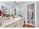 Bright bathroom featuring a double sink vanity and a combined shower and tub at 1261 Grovewood Dr, Clayton, NC 27520