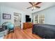 Cozy bedroom featuring a full bed, ceiling fan, and a connected en-suite bathroom at 1261 Grovewood Dr, Clayton, NC 27520