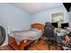 Bedroom featuring a wooden bed frame, hardwood floors, and a desk with multiple monitors at 1261 Grovewood Dr, Clayton, NC 27520