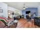 Cozy living room featuring light blue walls, hardwood floors, and a large window, providing ample natural light at 1261 Grovewood Dr, Clayton, NC 27520
