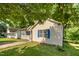 A view from the side of the house showing the manicured lawn and blue shutters on the home at 1261 Grovewood Dr, Clayton, NC 27520