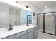 Modern bathroom features double sinks, quartz countertop, and a sleek glass enclosed shower at 133 Black Cloud Dr, Louisburg, NC 27549