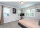 This airy bedroom offers great natural light with multiple windows and neutral decor at 133 Black Cloud Dr, Louisburg, NC 27549