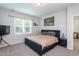 Bright bedroom featuring a comfortable bed, a window with blinds, and stylish decor at 133 Black Cloud Dr, Louisburg, NC 27549