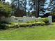 Welcoming community sign amidst lush greenery and landscaped flower beds at 133 Black Cloud Dr, Louisburg, NC 27549