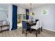 Elegant dining room with stylish light fixture and access to an outdoor deck at 133 Black Cloud Dr, Louisburg, NC 27549