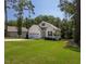 Beautiful two-story home with lush green lawn and mature trees surrounding the property at 133 Black Cloud Dr, Louisburg, NC 27549