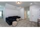 Cozy bonus room featuring a comfortable sofa, ottomans, and recessed lighting at 133 Black Cloud Dr, Louisburg, NC 27549