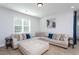Cozy living room featuring a comfortable sectional sofa and natural light at 133 Black Cloud Dr, Louisburg, NC 27549
