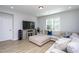 Comfortable living room with a large TV and entertainment center, ideal for relaxation at 133 Black Cloud Dr, Louisburg, NC 27549