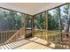 Relaxing screened porch with wood flooring, views of trees, and a nature view at 133 Black Cloud Dr, Louisburg, NC 27549