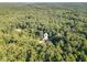 Far away shot of a home nestled in a dense forest landscape at 136 Vireo Ln, Hillsborough, NC 27278