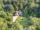 Aerial view of home surrounded by lush green trees and landscaping at 136 Vireo Ln, Hillsborough, NC 27278