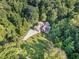 Stunning aerial view of home surrounded by lush greenery and a long driveway at 136 Vireo Ln, Hillsborough, NC 27278